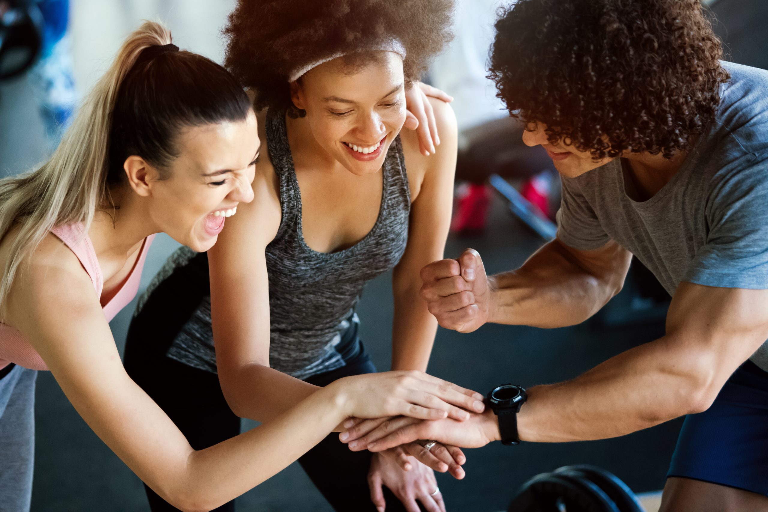 Happy successful fitness class after training in modern gym Happy successful fitness class after training in gym